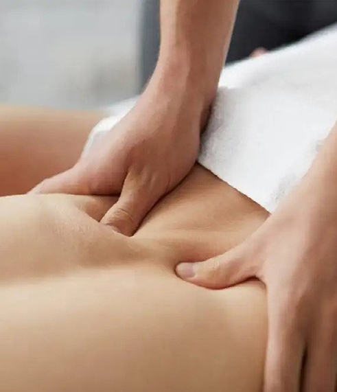 a close-up of fingers kneading the client’s back