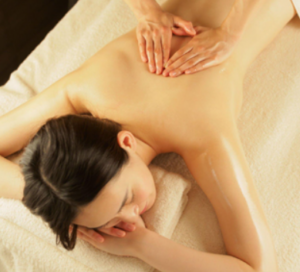 An image of a woman getting a massage on her bare back