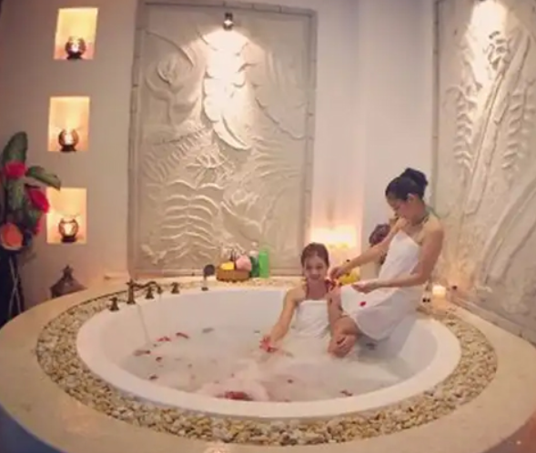 An image of a two women relaxing in a bath 